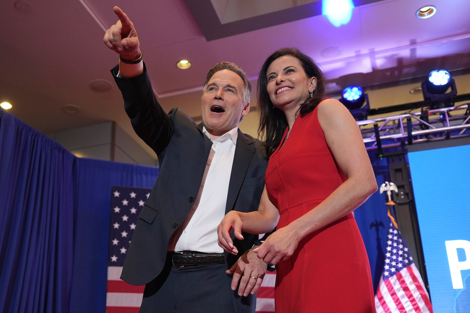 Republican Pennsylvania Senate candidate David McCormick, left, points to the crowd while on stage with his wife, Dina Powell, during an election night watch party, Wednesday, Nov. 6, 2024, in Pittsburgh. (AP Photo/Gene J. Puskar)