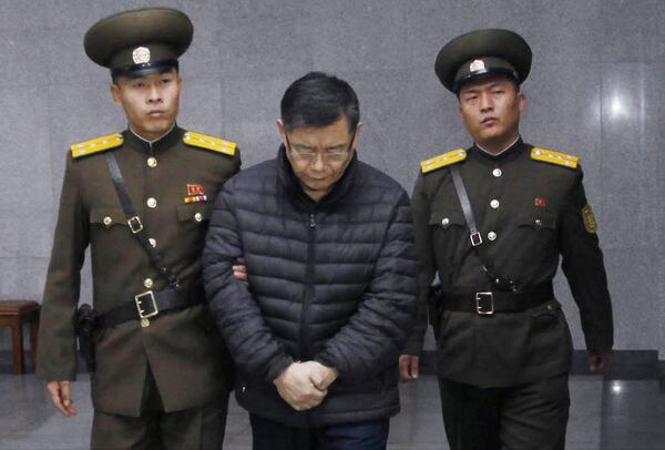 FILE - Hyeon Soo Lim, center, who pastors the Light Korean Presbyterian Church in Toronto, is escorted to his sentencing in Pyongyang, North Korea, Dec. 16, 2015. (AP Photo/Jon Chol Jin, File)