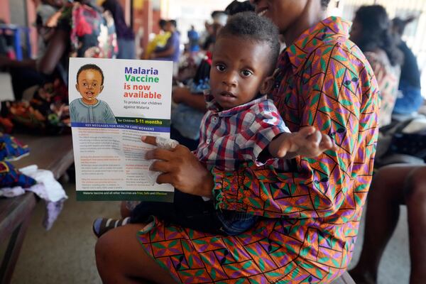 A woman waits to have the malaria vaccine R21/Matrix-M administered to her child at the comprehensive Health Centre in Agudama-Epie, in Yenagoa, Nigeria, Monday, Dec. 9, 2024. (AP Photo/Sunday Alamba)