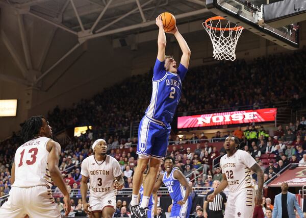 Duke guard Cooper Flagg (2) goes up to dunk during the first half of an NCAA college basketball game against Boston College, Saturday, Jan. 18, 2025, in Boston. (AP Photo/Mark Stockwell)