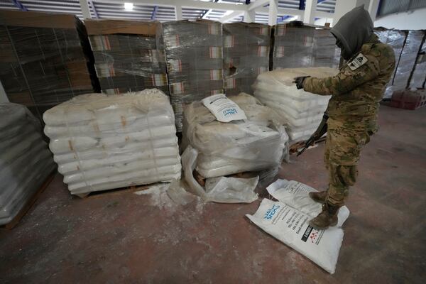 A Syrian member of the rebel group shows materials for manufacturing amphetamine pills known as Captagon, at the warehouse where the drug was manufactured before the fall of Bashar Assad government at a facility in Douma city, outskirts of Damascus, Syria, Friday, Dec. 13, 2024. (AP Photo/Hussein Malla)