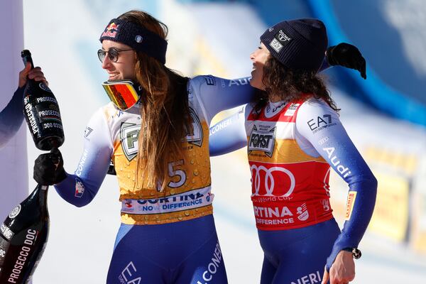 Italy's Sofia Goggia, left, winner of an alpine ski, women's World Cup downhill, celebrates with third-placed Italy's Federica Brignone, in Cortina d'Ampezzo, Italy, Saturday, Jan. 18, 2025 (AP Photo/Alessandro Trovati)