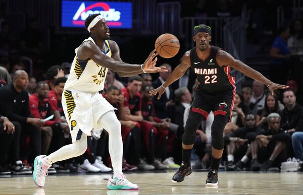 Indiana Pacers forward Pascal Siakam (43) passes as Miami Heat forward Jimmy Butler (22) defends during the first half of an NBA basketball game Thursday, Jan. 2, 2025, in Miami. (AP Photo/Lynne Sladky)