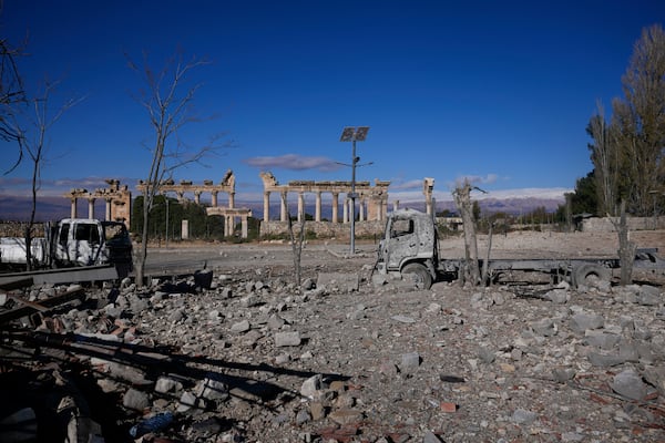 Damaged vehicles seen in front of the Roman temples of Baalbek in eastern Lebanon, Thursday, Nov. 28, 2024. (AP Photo/Hassan Ammar)