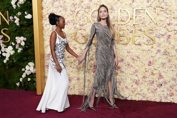 Zahara Jolie, left, and Angelina Jolie arrive at the 82nd Golden Globes on Sunday, Jan. 5, 2025, at the Beverly Hilton in Beverly Hills, Calif. (Photo by Jordan Strauss/Invision/AP)