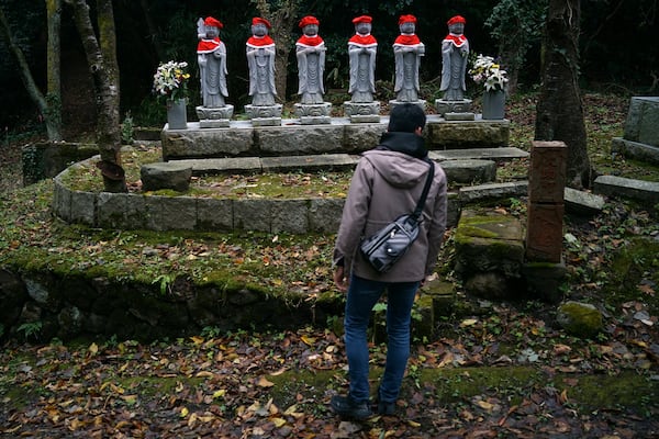 Stone statues are placed near the site of former Fourth Souai Dormitory for the mine workers from the Korean Peninsula, in Sado, Niigata prefecture, Japan, Sunday, Nov. 24, 2024. (AP Photo/Eugene Hoshiko)