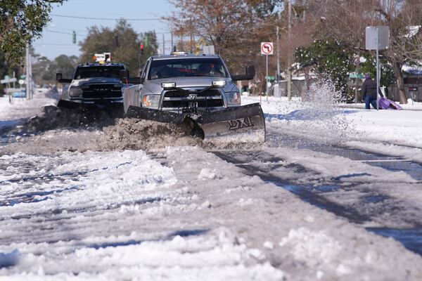 Snowplows clear snow from Jefferson Highway the day after a rare and record setting snowstorm in River Ridge, La., a suburb of New Orleans, Wednesday, Jan. 22, 2025. (AP Photo/Gerald Herbert)