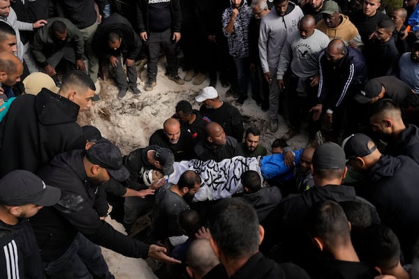 Mourners carry the body of a killed Palestinian during his funeral in the West Bank city of Tulkarem, Thursday, Dec. 26, 2024. (AP Photo/Matias Delacroix)