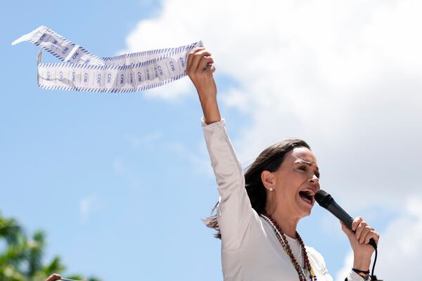 FILE - Opposition leader Maria Corina Machado holds up tally sheets during a protest against the reelection of President Nicolás Maduro one month after the disputed presidential vote which she says the opposition won by a landslide, in Caracas, Venezuela, Aug. 28, 2024. (AP Photo/Ariana Cubillos, File)