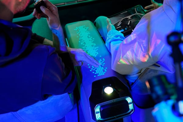 People demonstrate Human-Centric Interior Lighting at the Hyundai Mobis booth during the CES tech show Tuesday, Jan. 7, 2025, in Las Vegas. (AP Photo/John Locher)