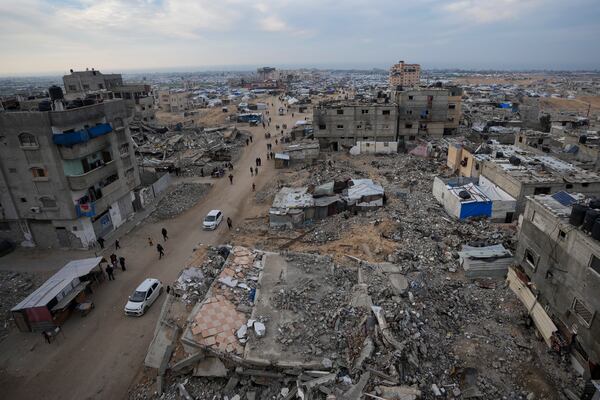 A tent camp for displaced Palestinians is set up amid destroyed buildings in the Khan Younis refugee camp, southern Gaza Strip, Saturday, Jan. 4, 2025. (AP Photo/Abdel Kareem Hana)