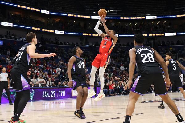 New Orleans Pelicans guard Dejounte Murray (5) goes up to shoot a jumper in the paint over Utah Jazz guard Isaiah Collier (13) in the second half of an NBA basketball game in New Orleans, Monday, Jan. 20, 2025. (AP Photo/Peter Forest)