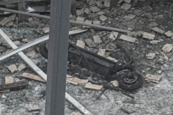 Investigators work near a scooter at the place where Lt. General Igor Kirillov, the head of Russia's Nuclear, Biological, and Chemical Defence Forces and his assistant Ilya Polikarpov were killed by an explosive device planted close to a residential apartment's block in Moscow, Russia, Tuesday, Dec. 17, 2024. (AP Photo)