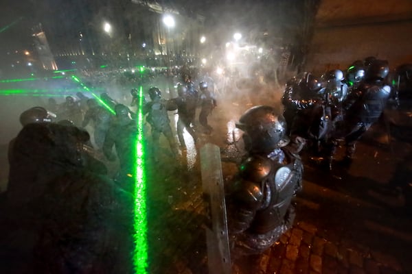 Police push away protesters pouring into the streets following Georgian Prime Minister Irakli Kobakhidze's announcement, rallying outside the parliament building in Tbilisi, Georgia, on Friday, Nov. 29, 2024. (AP Photo/Zurab Tsertsvadze)