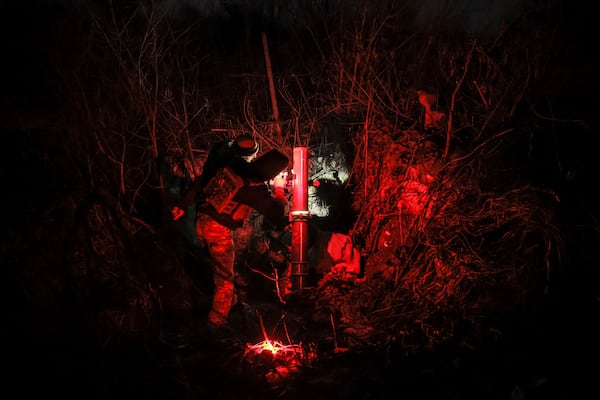 In this photo provided by Ukraine's 24th Mechanised Brigade press service, serviceman of the 24th Mechanised Brigade prepares to fire 120mm mortar towards Russian positions near Chasiv Yar town, in Donetsk region, Ukraine, Tuesday, Nov. 19, 2024. (Oleg Petrasiuk/Ukrainian 24th Mechanised Brigade via AP)