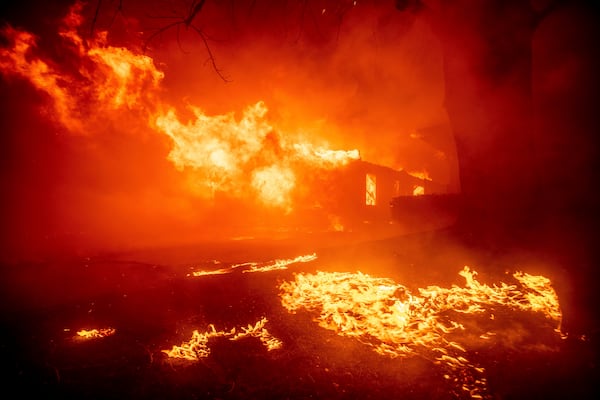 FILE - The Eaton Fire destroys a structure, Jan. 7, 2025, in Altadena, Calif. (AP Photo/Ethan Swope, File)