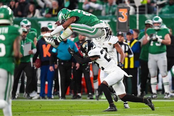 FILE - Philadelphia Eagles running back Saquon Barkley (26) hurdles over Jacksonville Jaguars cornerback Jarrian Jones (22) during the first half of an NFL football game Sunday, Nov. 3, 2024, in Philadelphia. (AP Photo/Chris Szagola, File)