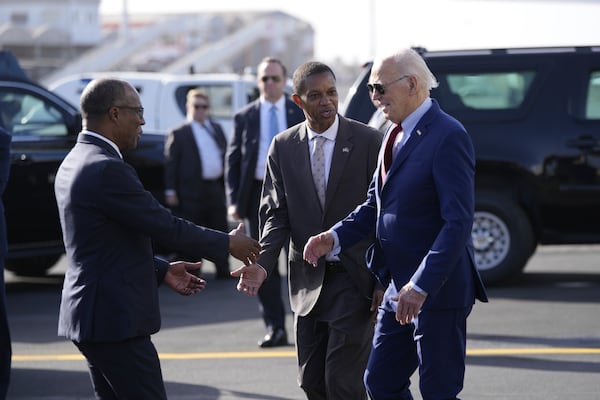 President Joe Biden is greeted by Cape Verde's Prime Minister Ulisses Correia e Silva at Amilcar Cabral international airport on Sal island, Cape Verde Monday, Dec. 2, 2024, en route to Angola as he makes his long-promised visit to Africa. (AP Photo/Ben Curtis)