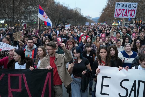 People march during a protest, a day after the assault on students was carried out by thugs with baseball bats, in Novi Sad, Serbia, Tuesday, Jan. 28, 2025. (AP Photo/Darko Vojinovic)