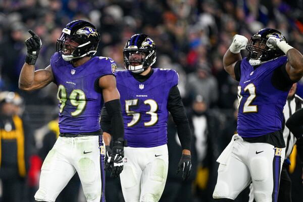 Baltimore Ravens linebacker Odafe Oweh (99) celebrates a sack with teammates linebacker Kyle Van Noy (53) and defensive tackle Nnamdi Madubuike (92) during the second half of an NFL wild-card playoff football game against the Pittsburgh Steelers, Saturday, Jan. 11, 2025, in Baltimore. (AP Photo/Nick Wass)