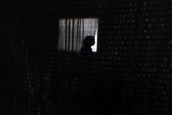 A Cuban migrant stands in a room at Martha Rosales' house as she waits for an appointment to apply for asylum in the United States through the CBP One app Wednesday, May 22, 2024, in Tijuana, Mexico. (AP Photo/Gregory Bull)