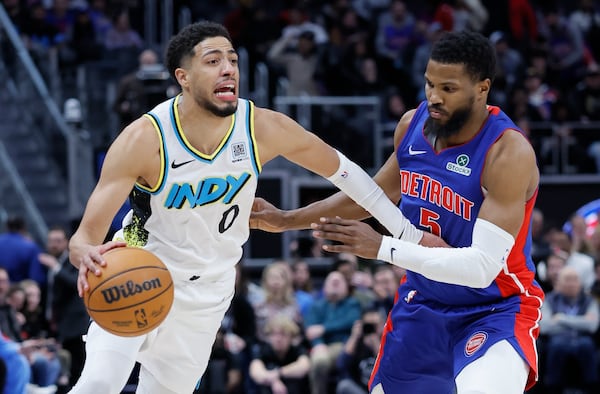 Indiana Pacers guard Tyrese Haliburton (0) drives against Detroit Pistons guard Malik Beasley (5) during the second half of an NBA basketball game Thursday, Jan. 16, 2025, in Detroit. (AP Photo/Duane Burleson)