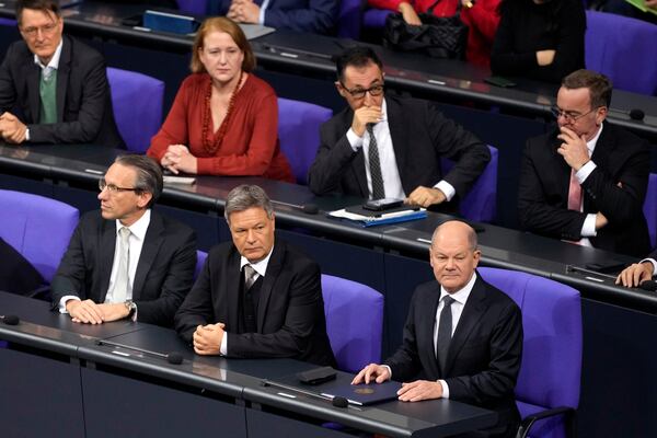 German Chancellor Olaf Scholz,, bottom right, attends a plenary session at the German parliament Bundestag where he faces a vote of confidence, Berlin, Germany, Monday, Dec. 16, 2024. (AP Photo/Markus Schreiber)