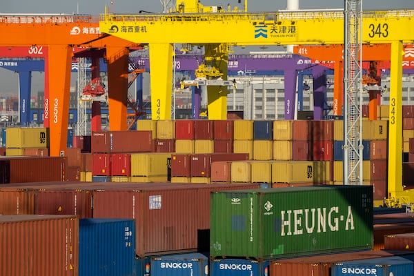 FILE - Shipping containers are stacked at a port in Tianjin, China, Jan. 16, 2023. (AP Photo/Mark Schiefelbein, File)