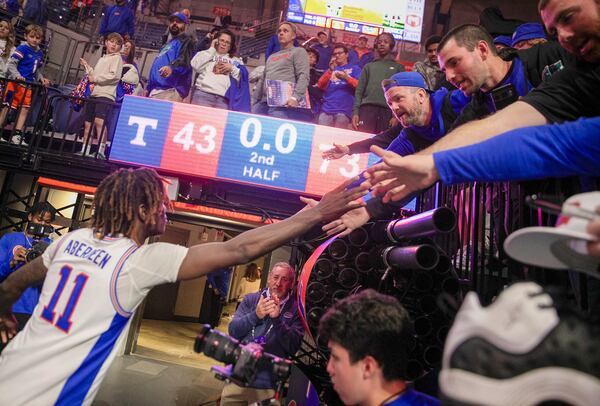 Florida guard Denzel Aberdeen (11) celebrates with fan after defeating Tennessee 73-43 in an NCAA college basketball game Tuesday, Jan. 7, 2025, in Gainesville, Fla. (AP Photo/Alan Youngblood)