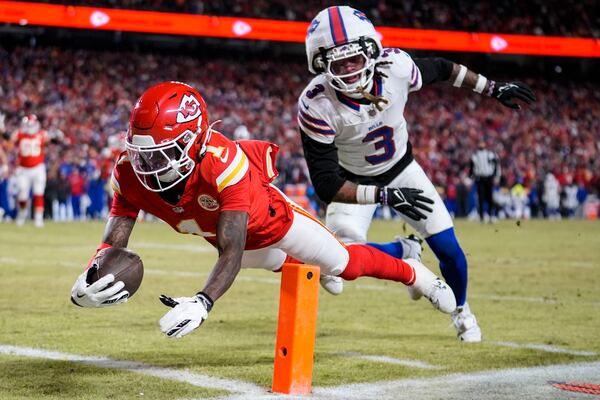 Kansas City Chiefs wide receiver Xavier Worthy (1) leaps into the end zone for a touchdown against Buffalo Bills safety Damar Hamlin (3) during the first half of the AFC Championship NFL football game, Sunday, Jan. 26, 2025, in Kansas City, Mo. (AP Photo/Ashley Landis)