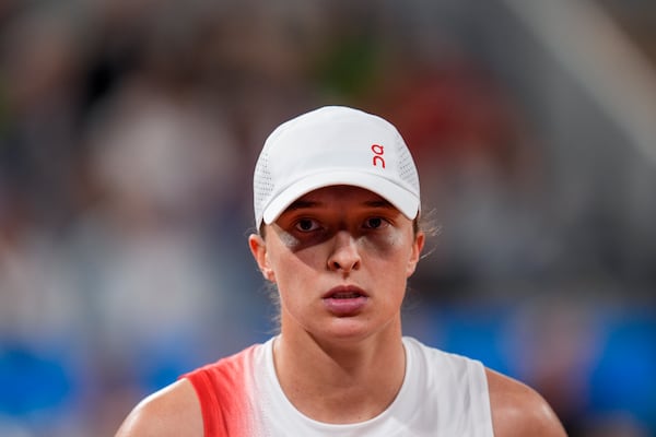 FILE - Iga Swiatek of Poland looks on during her match against Irina-Camelia Begu of Romania during a women's singles tennis competition, at the 2024 Summer Olympics, Saturday, July 27, 2024, in Paris, France. (AP Photo/Manu Fernandez, File)