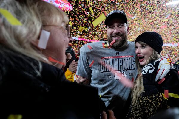 Donna Kelce stands with her son Kansas City Chiefs tight end Travis Kelce and Taylor Swift after the AFC Championship NFL football game against the Buffalo Bills, Sunday, Jan. 26, 2025, in Kansas City, Mo. (AP Photo/Ashley Landis)