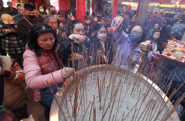 Worshippers visit a temple to pray on the first day of the Lunar New Year celebrations in Taipei, Taiwan, Wednesday, Jan. 29, 2025. (AP Photo/Chiang Ying-ying)