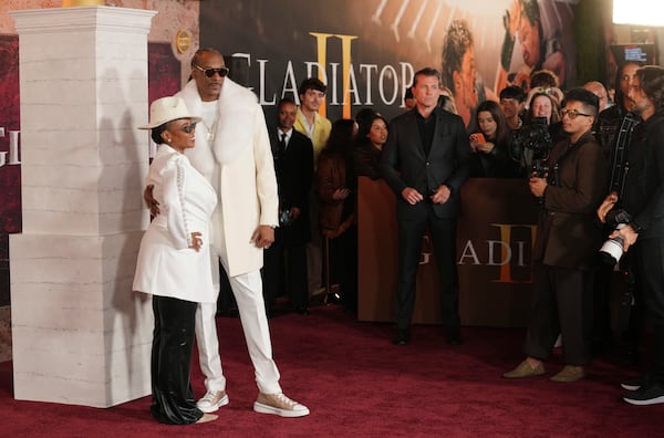 Snoop Dogg and his wife Shante Broadus pose together at the premiere of the film "Gladiator II" on Monday, Nov. 18, 2024, at the TCL Chinese Theatre in Los Angeles. (AP Photo/Chris Pizzello)