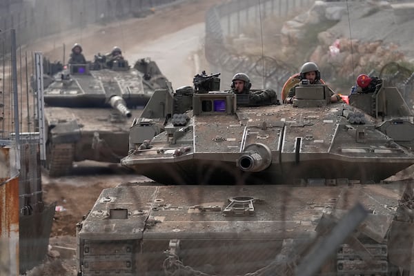 Israeli army tanks maneuver near the so-called Alpha Line that separates the Israeli-annexed Golan Heights from Syria, in the town of Majdal Shams, Wednesday, Dec. 11, 2024. (AP Photo/Matias Delacroix)