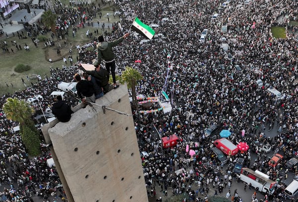 Syrians continue to celebrate the ousting of Bashar al-Assad's government, at Umayyad Square, in Damascus, Syria, Friday, Dec. 20, 2024. (AP Photo/Hussein Malla)