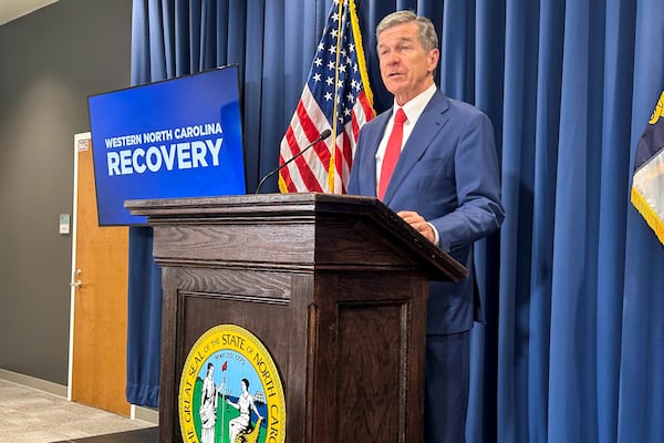 FILE - North Carolina Gov. Roy Cooper unveils a report during a press conference in Raleigh, N.C., Oct. 23, 2024. (AP Photo/Gary D. Robertson, File)