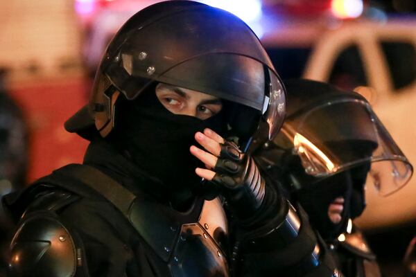 Police stand blocking a street outside the parliament's building during a rally to continue protests against the government's decision to suspend negotiations on joining the European Union in Tbilisi, Georgia, on Monday, Dec. 2, 2024. (AP Photo/Zurab Tsertsvadze)