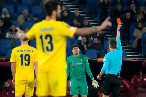 Braga's goalkeeper Matheus Magalhaes sees the red card after deflecting the ball with his arm outside the penalty box during the Europa League Soccer match between Roma and Braga at Rome's Olympic stadium, Thursday, Dec. 12, 2024. (AP Photo/Gregorio Borgia)