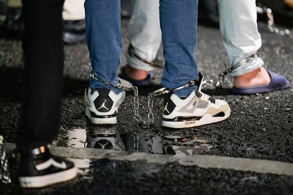 FILE - Shackled Ecuadorian migrants line up to board a plane for deportation from the Albrook airport in Panama City, Aug. 29, 2024. (AP Photo/Matias Delacroix, File)