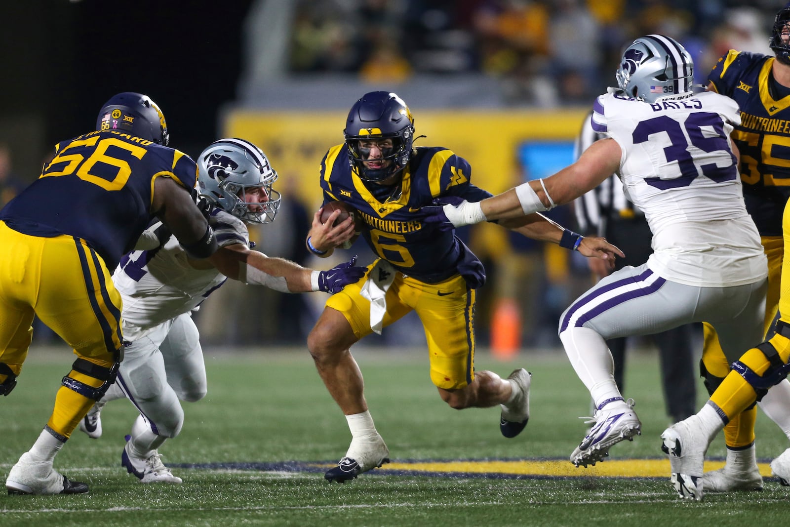 West Virginia quarterback Garrett Greene (6) rushes the ball against Kansas State during the frist half of an NCAA college football game, Saturday, Oct. 19, 2024, in Morgantown, W.Va. (AP Photo/William Wotring)