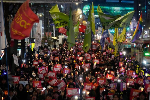 FILE - Protesters march to the presidential office after a candlelight vigil against South Korean President Yoon Suk Yeol in Seoul, South Korea, Dec. 5, 2024. (AP Photo/Ahn Young-joon, File)