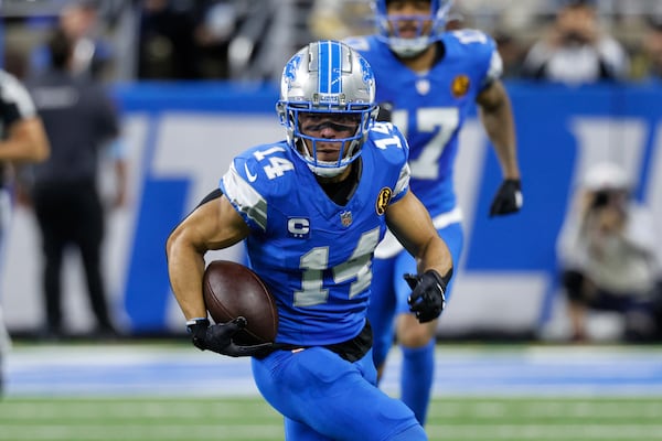 Detroit Lions wide receiver Amon-Ra St. Brown (14) runs after a catch during the first half of an NFL football game against the Chicago Bears, Sunday, Nov. 17, 2024, in Detroit. (AP Photo/Carlos Osorio)