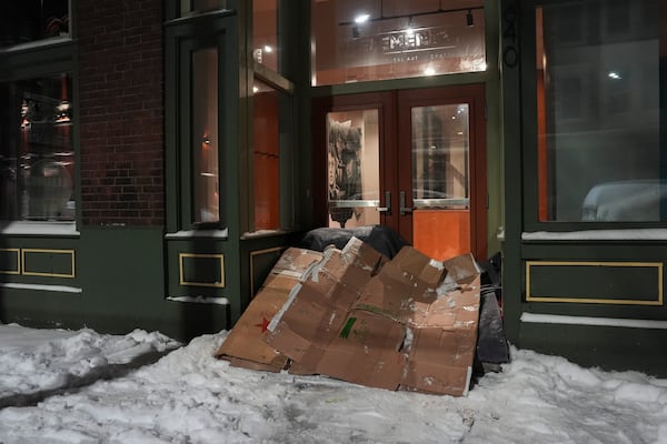 A makeshift shelter sits at the entrance to a building, Tuesday, Jan. 7, 2025, in Cincinnati. (AP Photo/Joshua A. Bickel)