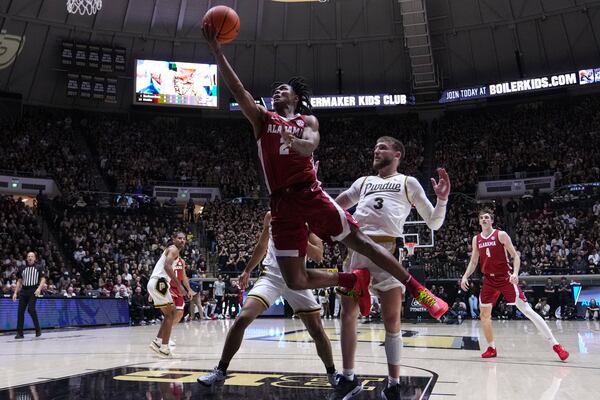 Alabama guard Aden Holloway (2) shoots in front of Purdue guard Braden Smith (3) during the first half of an NCAA college basketball game in West Lafayette, Ind., Friday, Nov. 15, 2024. (AP Photo/Michael Conroy)