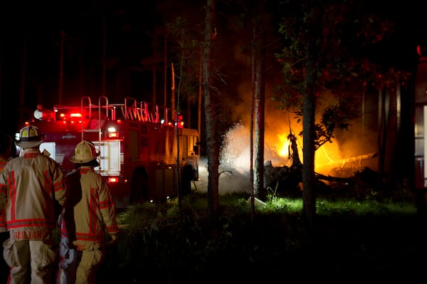 Local emergency responders extinguish the fires caused by a CV-22 Osprey crash that occurred at Eglin range June 13, 2012 near Eglin Air Force Base, Fla. (Airman 1st Class Christopher Williams, U.S. Air Force via AP)