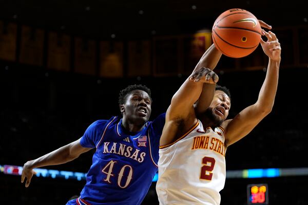 Kansas forward Flory Bidunga (40) fights for a rebound with Iowa State forward Joshua Jefferson (2) during the first half of an NCAA college basketball game, Wednesday, Jan. 15, 2025, in Ames, Iowa. (AP Photo/Charlie Neibergall)