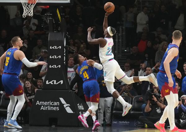 Miami Heat forward Jimmy Butler (22) shoots over Denver Nuggets guard Russell Westbrook (4) during the first half of an NBA basketball game, Friday, Jan. 17, 2025, in Miami. (AP Photo/Lynne Sladky)