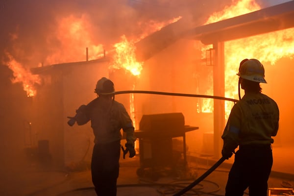 Firefighters battle the Eaton Fire as it engulfs structures Wednesday, Jan. 8, 2025 in Altadena, Calif. (AP Photo/Nic Coury)