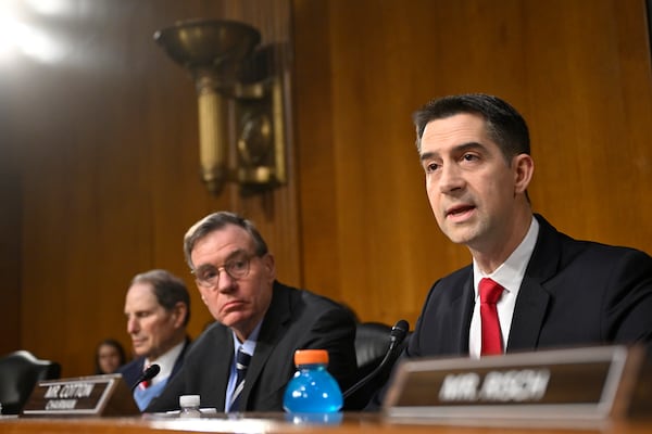 Chairman Sen. Tom Cotton, R-Ark., right, questions former Rep. Tulsi Gabbard, President Donald Trump's nominee to be the Director of National Intelligence, as Vice Chair Sen. Mark Warner, D-Va., center, listens during the Senate Intelligence Committee for Gabbard's confirmation hearing at the U.S. Capitol on Thursday, Jan. 30, 2025, in Washington. (AP Photo/John McDonnell)